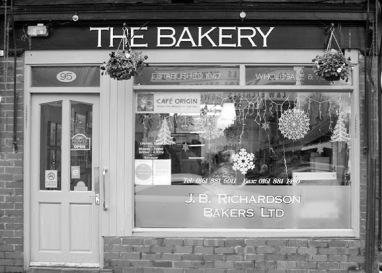 black and white picture of a bakery shop front
